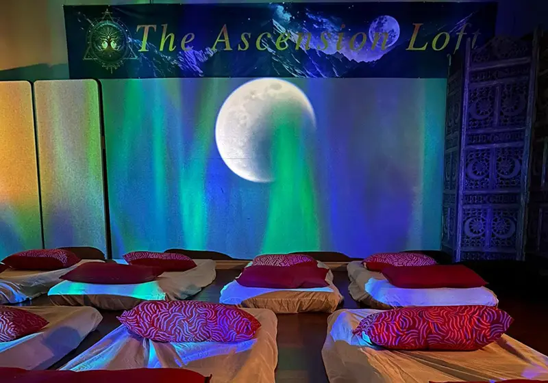 The Ascension Loft healing space with green ambient lighting and floor mattresses — Group Reiki Healing in Abbotsford BC